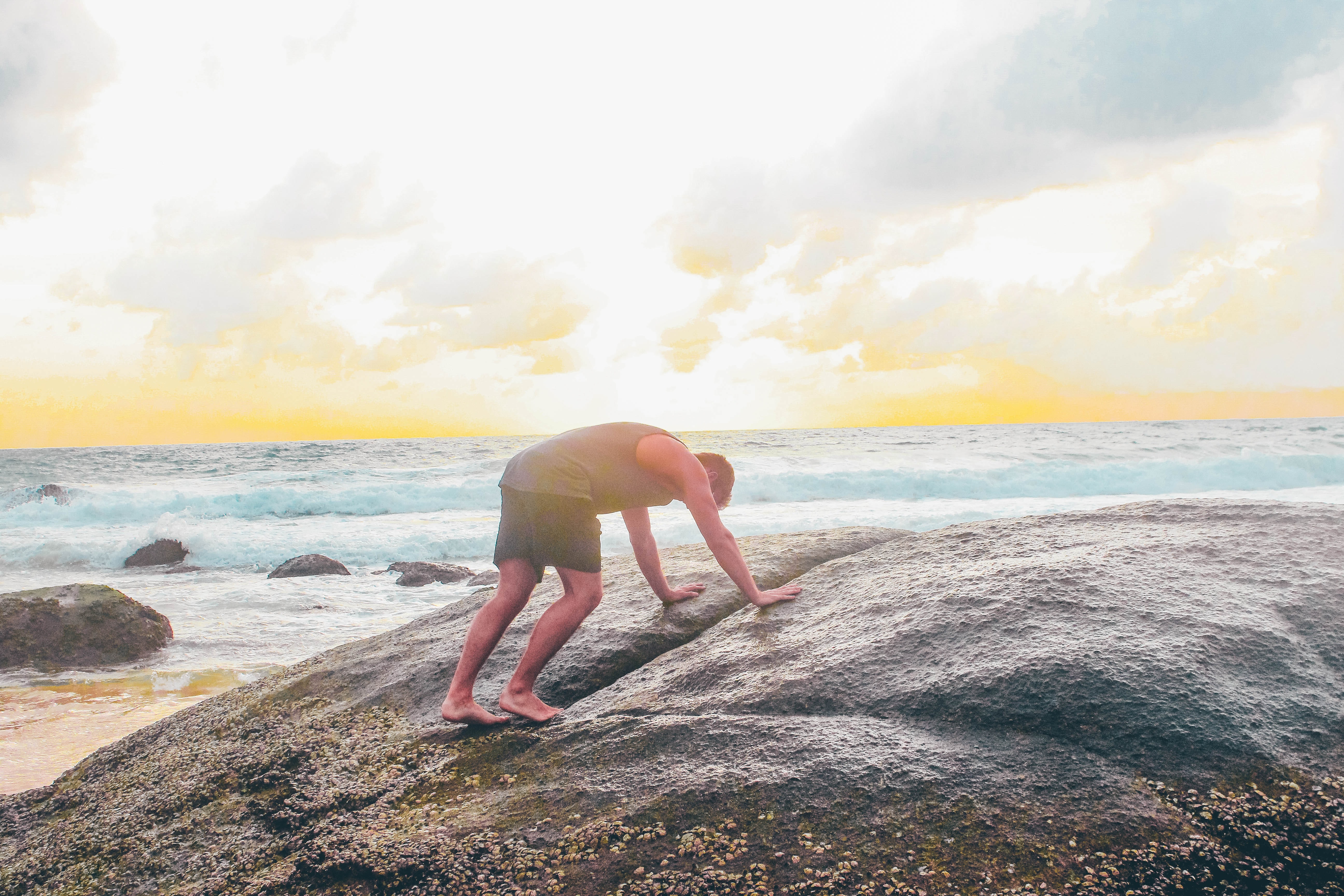 person trying to climb on rock